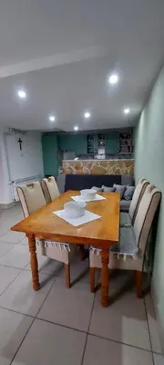 a wooden table with chairs around it in a room at Green House Izvor Vrilo in Tomislavgrad