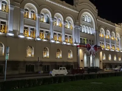 a white truck parked in front of a building at night at Park apartment in Banja Luka