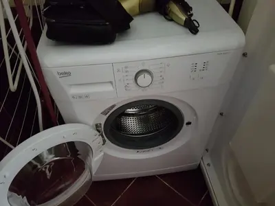 a washing machine with a black purse on top of it at Park apartment in Banja Luka