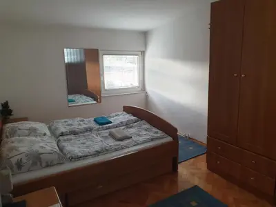 a bedroom with a bed and a mirror in it at Park apartment in Banja Luka
