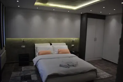 a bedroom with a large bed with towels on it at De Lux Apartment Maki in Banja Luka
