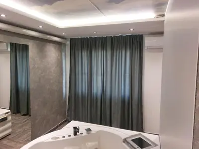a bathroom with a bath tub and a sink at De Lux Apartment Maki in Banja Luka