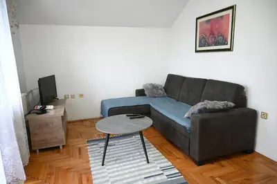 a living room with a couch and a table at Apartman Felix in Laktaši