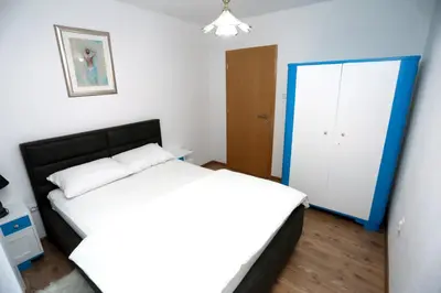 a bedroom with a large bed and a closet at Apartman Felix in Laktaši