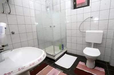 a bathroom with a shower and a toilet and a sink at Apartman Felix in Laktaši