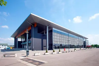 a large blue building with a lot of windows at Apartman Felix in Laktaši