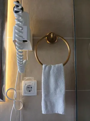 a towel rack with a blow dryer in a bathroom at Provence rooms in Banja Luka