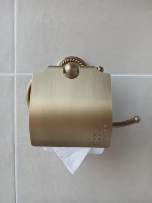 a toilet paper dispenser on the wall of a bathroom at Provence rooms in Banja Luka