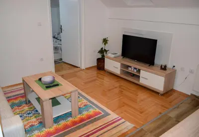 a living room with a television and a coffee table at Apartman MAŠA in Banja Luka