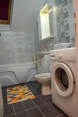 a bathroom with a washing machine and a toilet at Apartman MAŠA in Banja Luka