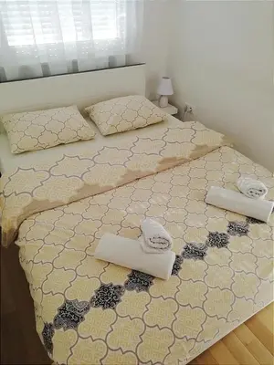 a bedroom with two beds with towels on them at Centar Banja Luka Apartman MIKI in Banja Luka