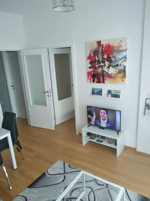 a living room with a flat screen tv on a stand at Centar Banja Luka Apartman MIKI in Banja Luka