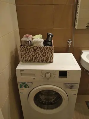 a washing machine with a basket on top of it at Centar Banja Luka Apartman MIKI in Banja Luka
