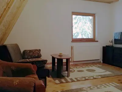 a living room with a couch and a table and a window at Villa Franka - Vlašić in Vlasic