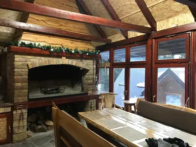 a living room with a fireplace and a wooden table at Villa Franka - Vlašić in Vlasic