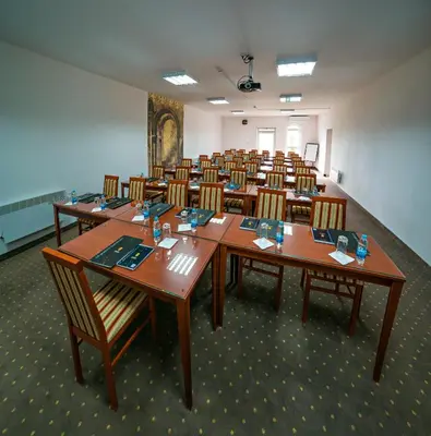 a room with rows of tables and chairs at Hotel San Terme Laktaši in Laktaši