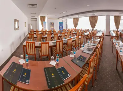 a row of tables and chairs in a room at Hotel San Terme Laktaši in Laktaši