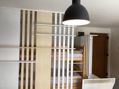 a staircase leading to a bunk room with a bunk bed at Apartments Vlašić in Vlasic