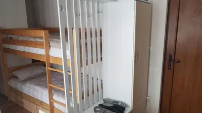 a room with a bunk bed with white rails at Apartments Vlašić in Vlasic