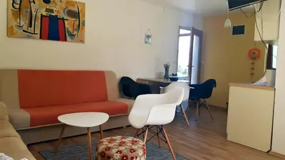 a living room with a couch and a table and chairs at Apartments Vlašić in Vlasic