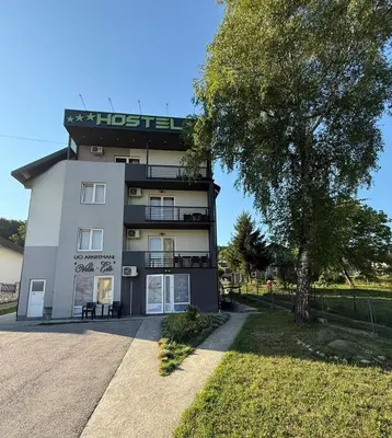 a building with a tree in front of it at Vela-edo in Zavidovići