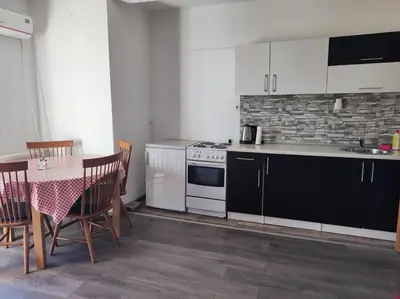 a kitchen with a table and a stove top oven at Vela-edo in Zavidovići