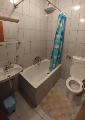 a bathroom with a tub and a toilet and a sink at Vila San in Banja Luka