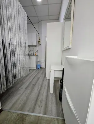 an empty room with a table and a kitchen at Vila San in Banja Luka