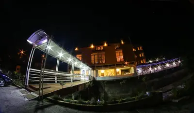 a building with lights on it at night at Hotel Fontana in Zenica