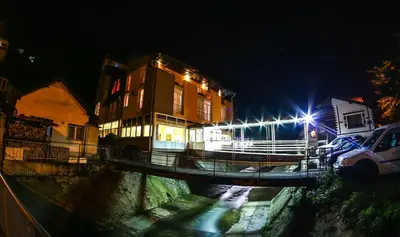 a boat on a river at night with lights at Hotel Fontana in Zenica
