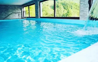 a swimming pool with a waterfall in a house at Lola's House in Jajce