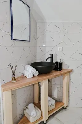 a bathroom with a sink on a wooden table at Lola's House in Jajce