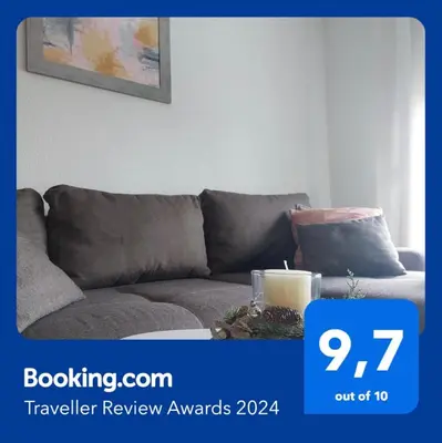 a gray couch in a living room with a candle at Stan-apartman A&A in Banja Luka
