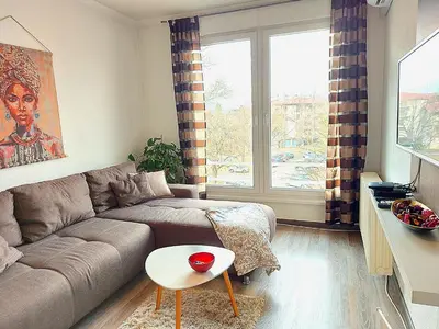 a living room with a couch and a window at Stan-apartman A&A in Banja Luka