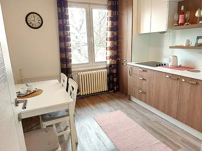 a kitchen with a table and a dining room at Stan-apartman A&A in Banja Luka