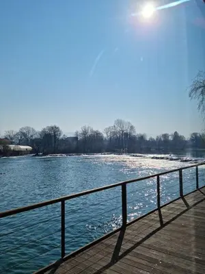 a boardwalk with a view of a body of water at Hotel Opal Exclusive Bihać in Bihać