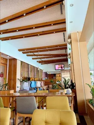 a restaurant with chairs and tables and a television at Hotel Opal Exclusive Bihać in Bihać