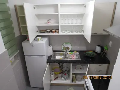 a small kitchen with a sink and a refrigerator at Apartman Tea 2 in Banja Luka