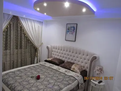 a bedroom with a large bed and a blue ceiling at Apartman Tea 2 in Banja Luka