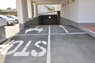 a parking lot with a bus sign painted on it at Apartman Tea 2 in Banja Luka