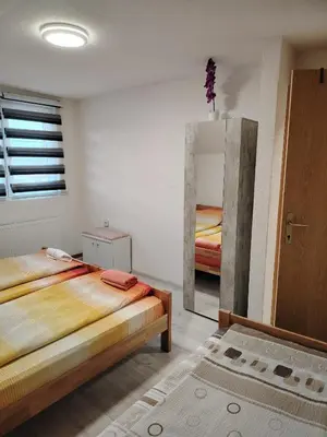 a bedroom with two beds and a mirror at Medif apartments in Visoko