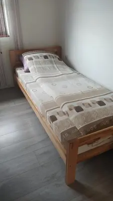 a bed in a room with a wooden frame at Medif apartments in Visoko
