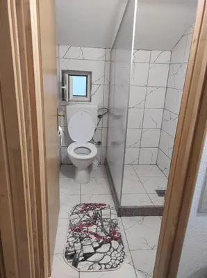a bathroom with a toilet and a shower at Medif apartments in Visoko