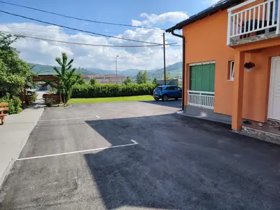 a car parked in a parking lot next to a building at Medif apartments in Visoko