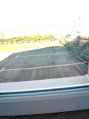 a tennis court seen through a window at Medif apartments in Visoko