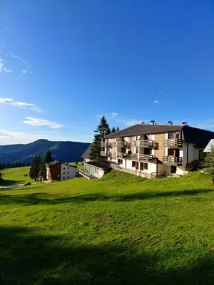 a large house on a hill with a green field at Vlašićka idila apartman Eko Fis 507 in Vlasic