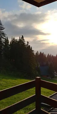 a fence with a view of a field and trees at Vlašićka idila apartman Eko Fis 507 in Vlasic