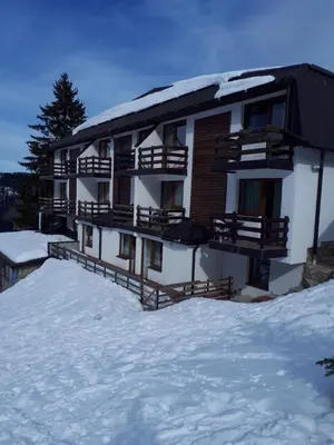 a building on top of a snow covered mountain at Vlašićka idila apartman Eko Fis 507 in Vlasic