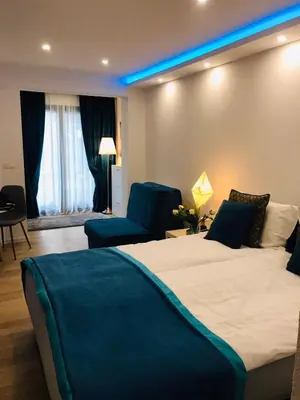 a hotel room with a large bed and blue lighting at Moonlight Visoko in Visoko