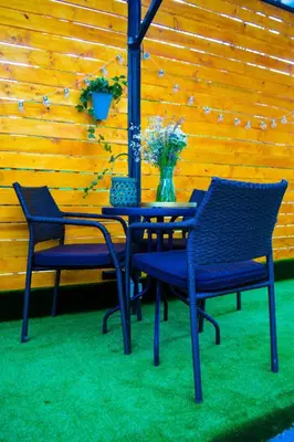 two chairs and a table with a vase of flowers at Moonlight Visoko in Visoko